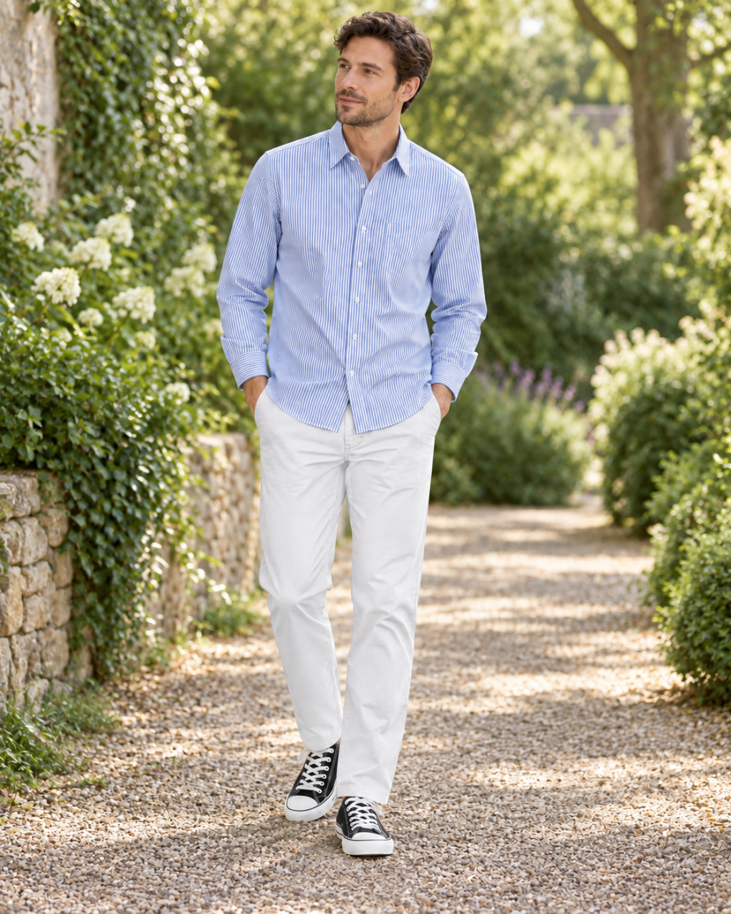 An adult man wearing an Alice-inspired blue-and-white striped shirt, white chinos and black canvas sneakers.